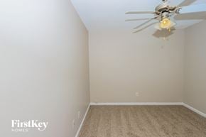 Mcdonough house for rent - a bedroom with a ceiling fan and a carpet