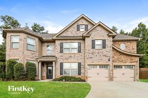 Cumming house for rent - a brick house with two garage doors
