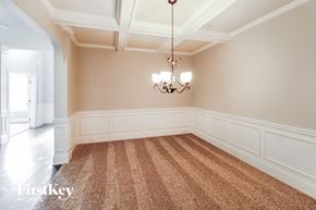 Cumming house for rent - a dining room with a carpet and a chandelier