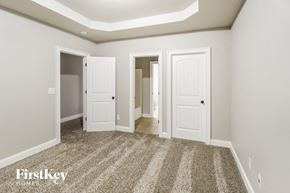 Cumming house for rent - a bedroom with three doors and a carpeted floor