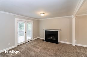 Acworth house for rent - a living room with a fireplace and a door to a patio