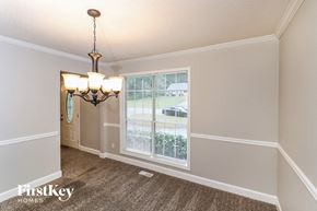 Acworth house for rent - a dining room with a large window and a chandelier