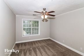 Acworth house for rent - a bedroom with a ceiling fan and a window