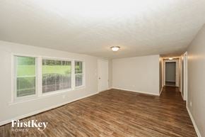 Red Oak house for rent - the living room and hallway of an empty house with wood flooring