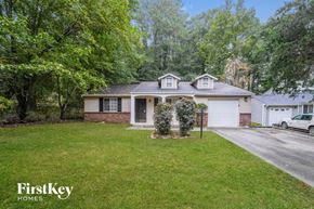 Stone Mountain house for rent - a white and brick house with a lawn and trees