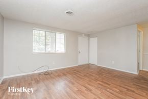 Stone Mountain house for rent - a living room with wood floors and white walls and a window