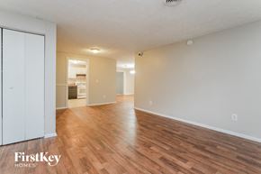 Stone Mountain house for rent - the living room and dining room of an apartment with wood flooring and white walls