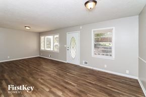 Union City house for rent - the living room of an empty house with a wooden floor