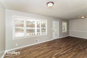 Union City house for rent - the living room of an empty house with a wooden floor