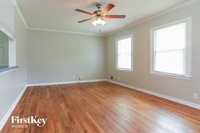 Riverdale house for rent - a living room with wood floors and a ceiling fan