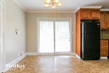Riverdale house for rent - a kitchen with a refrigerator and cabinets and a doorway