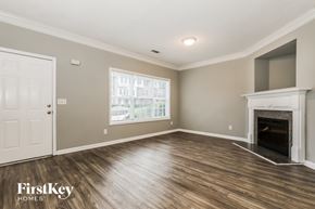 Atlanta house for rent - A spacious living room with a fireplace and a large window.