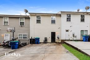 Atlanta house for rent - A two-story building with a basketball hoop in front of it.