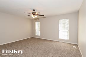 Norcross house for rent - a bedroom with carpet and a ceiling fan