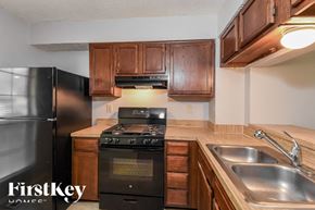 Norcross house for rent - a kitchen with a stove and a sink and a refrigerator