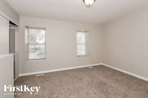 Norcross house for rent - a spacious room with carpet and two windows