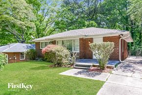 Forest Park house for rent - a brick house with a lawn and a porch