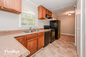 Forest Park house for rent - a kitchen with a sink and a black refrigerator