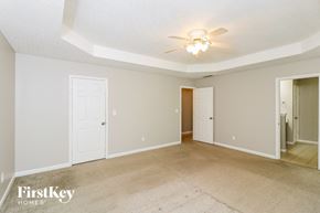 Riverdale house for rent - the living room and dining room of a house with a ceiling fan