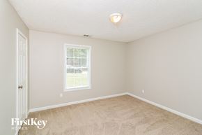 Riverdale house for rent - a bedroom with a carpeted floor and a window