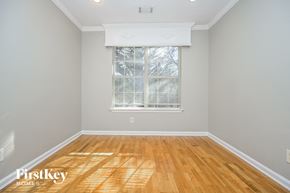 Rex house for rent - a living room with wood floors and a window