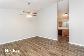 Austell house for rent - A room with a ceiling fan and wooden flooring.