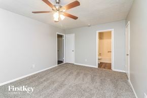 Austell house for rent - A spacious room with a ceiling fan and carpeted floor.