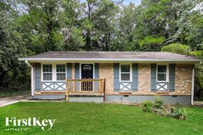 Jonesboro house for rent - A small house with a porch and a black door.