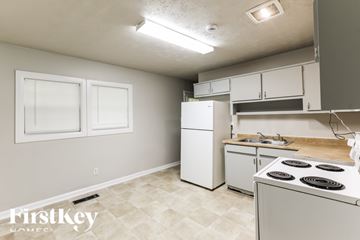 Jonesboro house for rent - A kitchen with a stove, sink, and cabinets.