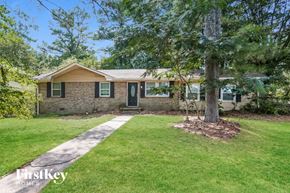 Riverdale house for rent - a small brick house with a tree in the front