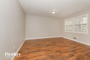 Riverdale house for rent - the living room of an empty house with wood flooring