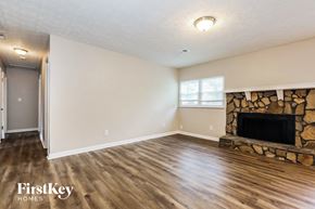 Jonesboro house for rent - A living room with a fireplace and wood flooring.