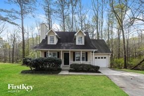 Jonesboro house for rent - a white house with a lawn and trees