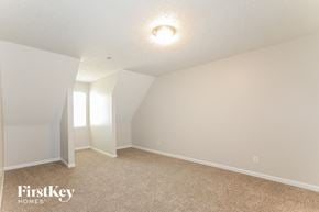 Jonesboro house for rent - a bedroom with white walls and carpet and a window