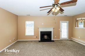 Fayetteville house for rent - the living room has a fireplace and a ceiling fan