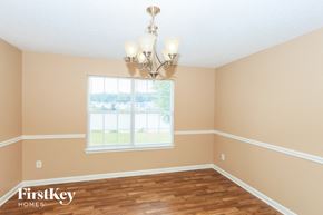 Fayetteville house for rent - a dining room with a window and a chandelier