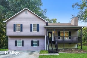 Douglasville house for rent - A house with a porch and a staircase leading to the front door.