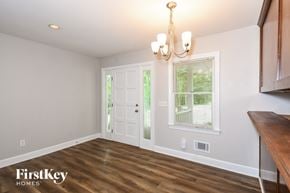 Canton house for rent - A room with a wooden floor and a chandelier hanging from the ceiling.