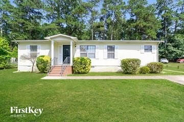 Mcdonough house for rent - a small white house with a lawn and trees