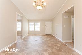 Mcdonough house for rent - the spacious living room and dining room with a chandelier