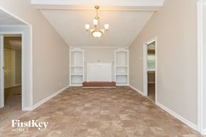 Mcdonough house for rent - a empty living room with white shelves and a chandelier