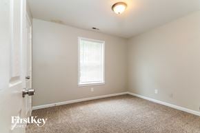 Mcdonough house for rent - a bedroom with a carpeted floor and a window