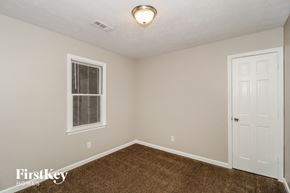Peachtree City house for rent - a bedroom with a carpeted floor and a white door