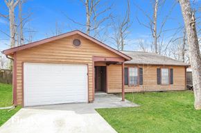 Lawrenceville house for rent - a wood sided home with a white garage door