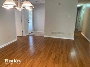Tyrone house for rent - an empty living room with a hard wood floor
