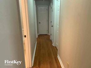 Tyrone house for rent - a hallway with wooden floors and a white door