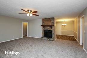 Lawrenceville house for rent - a living room with a fireplace and a ceiling fan