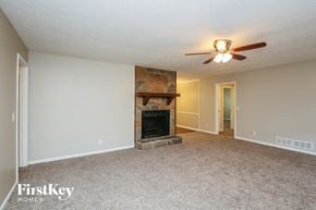 Lawrenceville house for rent - a living room with a fireplace and a ceiling fan