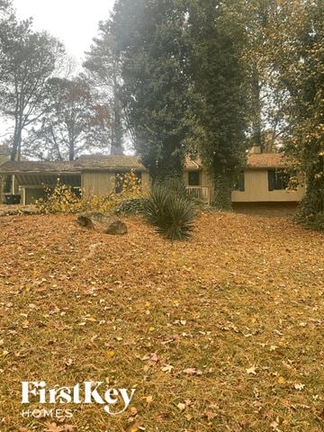 Stone Mountain house for rent - a house in the woods with a yard with dead grass