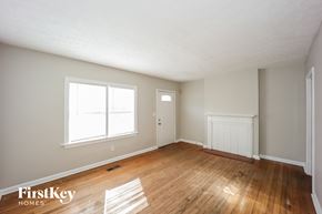 Atlanta house for rent - the living room and dining room of a house with wood floors